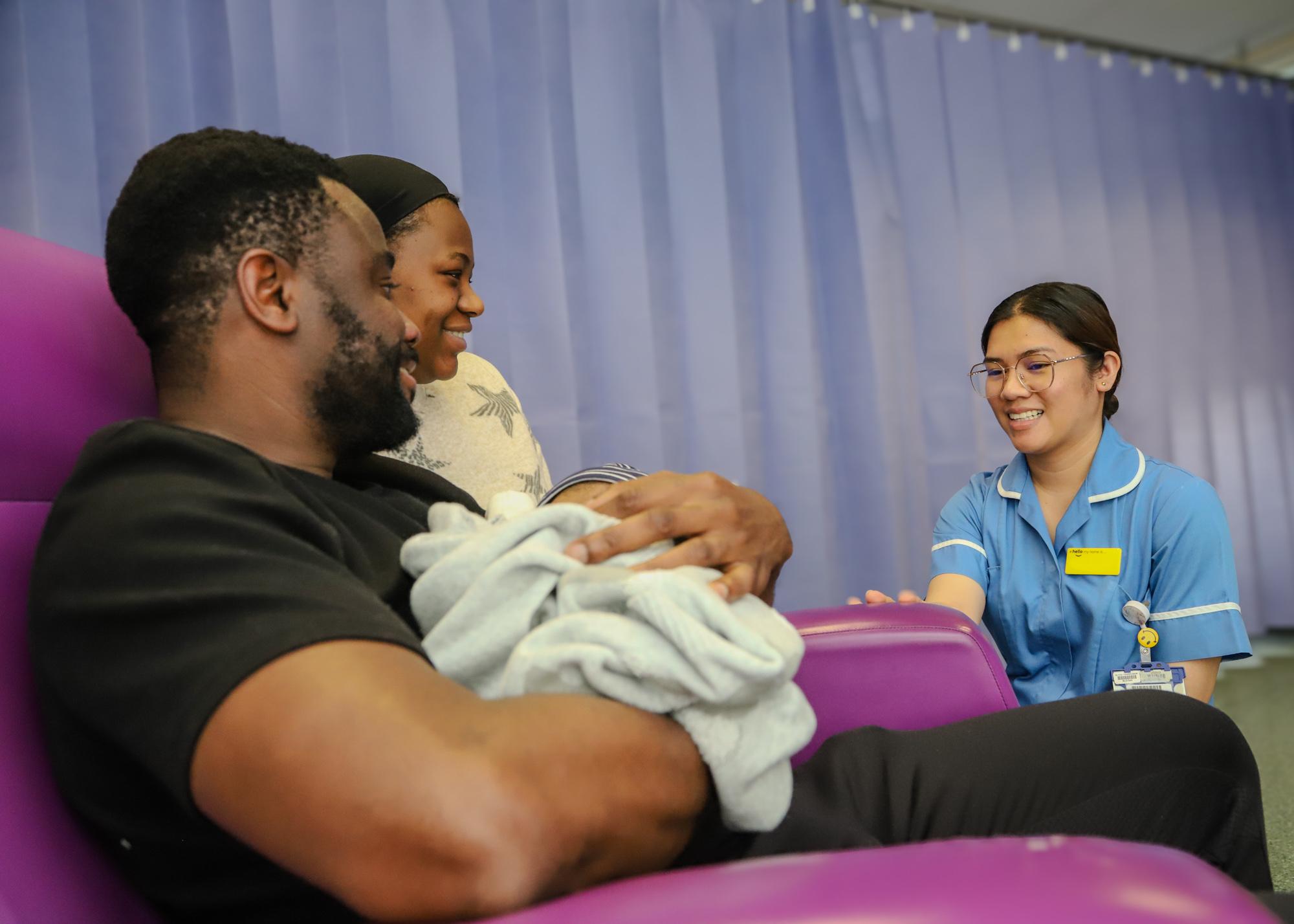 Family with newborn and nurse
