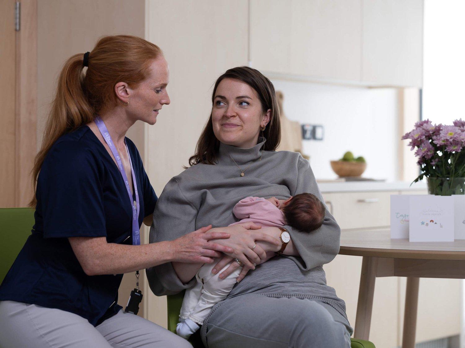Nurse supporting a mother with her newborn